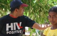 Man wearing an 'HIV Positive' shirt standing next to a girl